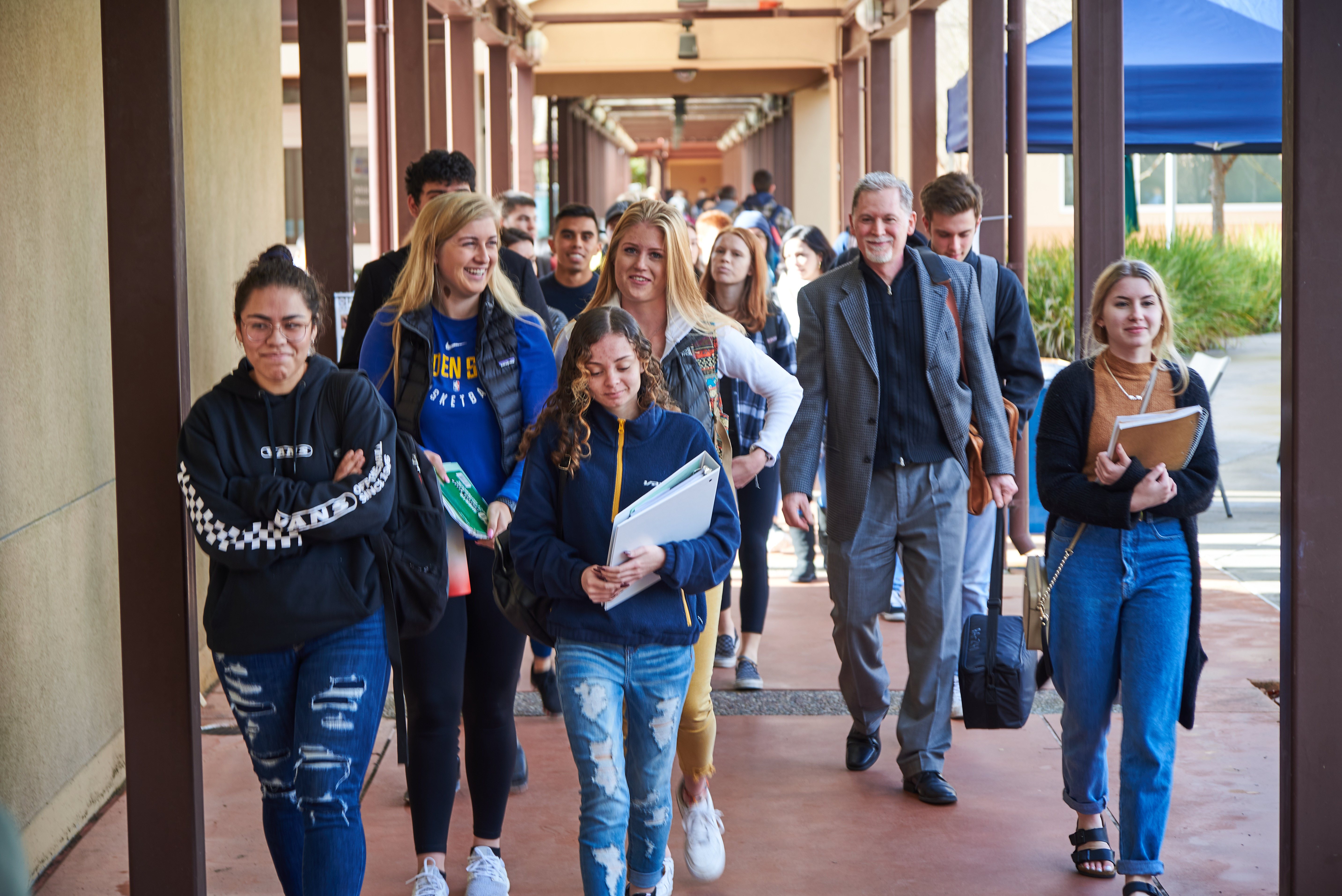 A group of students walking down a hallway