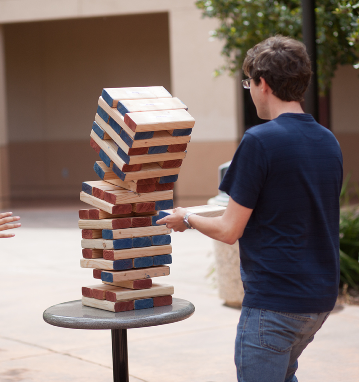 A jingo tower falling on a student