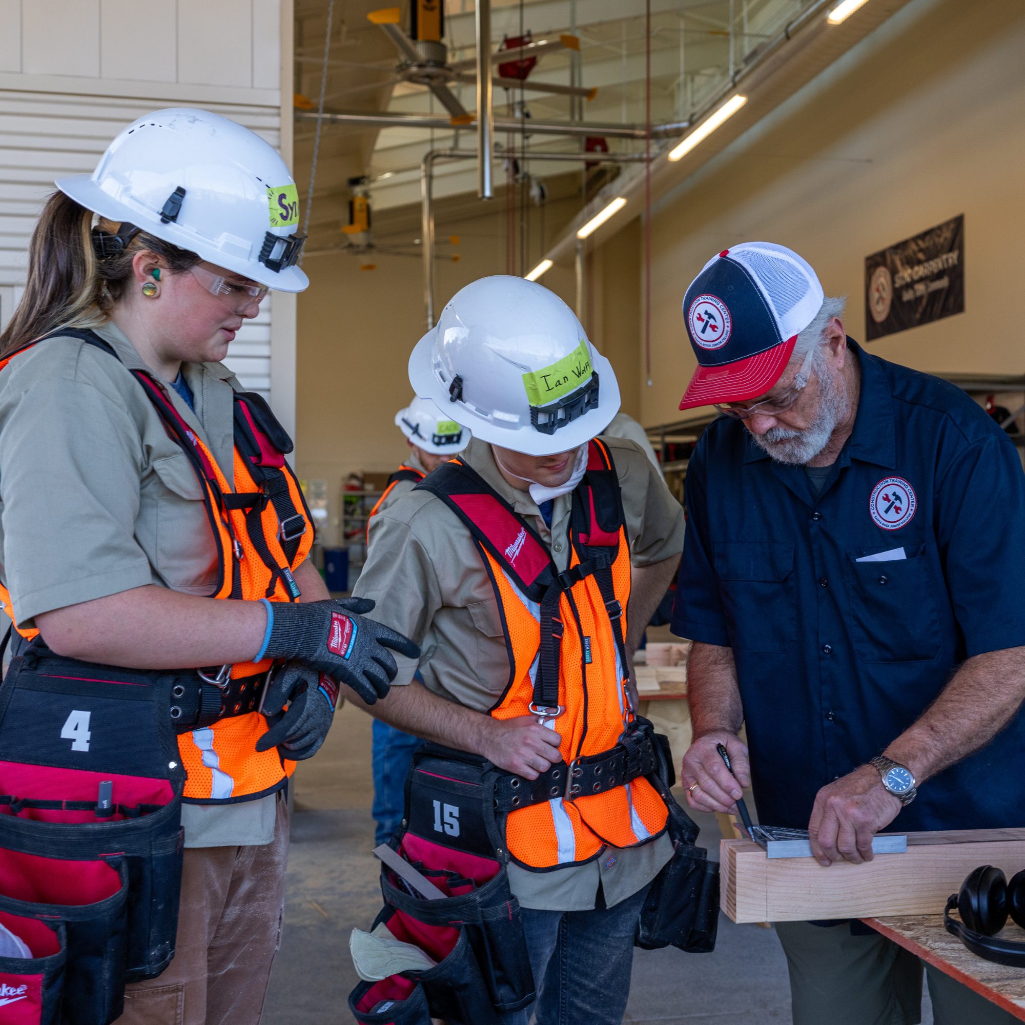 Carpentry students working with instructor